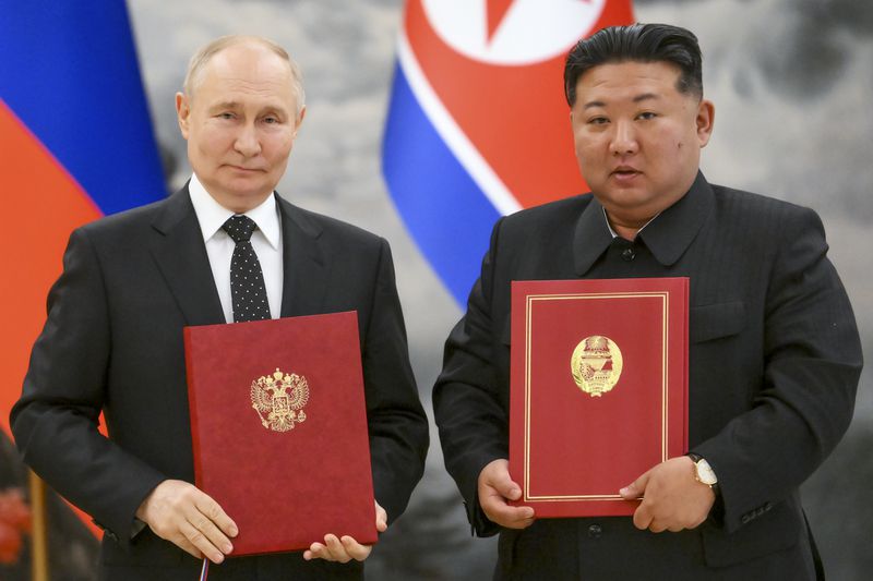 Russian President Vladimir Putin, left, and North Korea's leader Kim Jong Un pose for a photo during a signing ceremony of the new partnership in Pyongyang, North Korea, on Wednesday, June 19, 2024. Putin and North Korean leader Kim Jong Un signed a new partnership that includes a vow of mutual aid if either country is attacked, during a Wednesday summit that came as both face escalating standoffs with the West. (Kristina Kormilitsyna, Sputnik, Kremlin Pool Photo via AP)