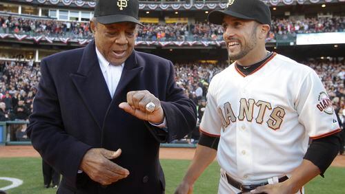 FILE - San Francisco Giants Hall of Famer Willie Mays, left, looks over his 2010 World Series championship ring that was presented to him by Giants center fielder Andres Torres, right, before their baseball game against the St. Louis Cardinals in San Francisco, Saturday, April, 9, 2011. Willie Mays, the electrifying “Say Hey Kid” whose singular combination of talent, drive and exuberance made him one of baseball’s greatest and most beloved players, has died. He was 93. Mays' family and the San Francisco Giants jointly announced Tuesday night, June 18, 2024, he had died earlier in the afternoon in the Bay Area. (AP Photo/Eric Risberg, Pool, File)