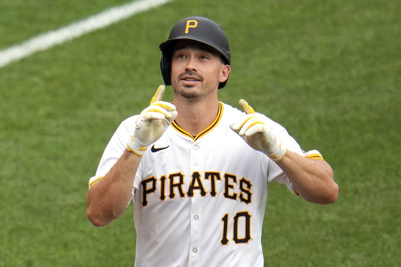Pittsburgh Pirates' Bryan Reynolds celebrates as he crosses home plate after hitting a solo home run off Cincinnati Reds relief pitcher Nick Martinez during the eighth inning of a baseball game in Pittsburgh, Wednesday, June 19, 2024. The Pirates won 1-0. (AP Photo/Gene J. Puskar)