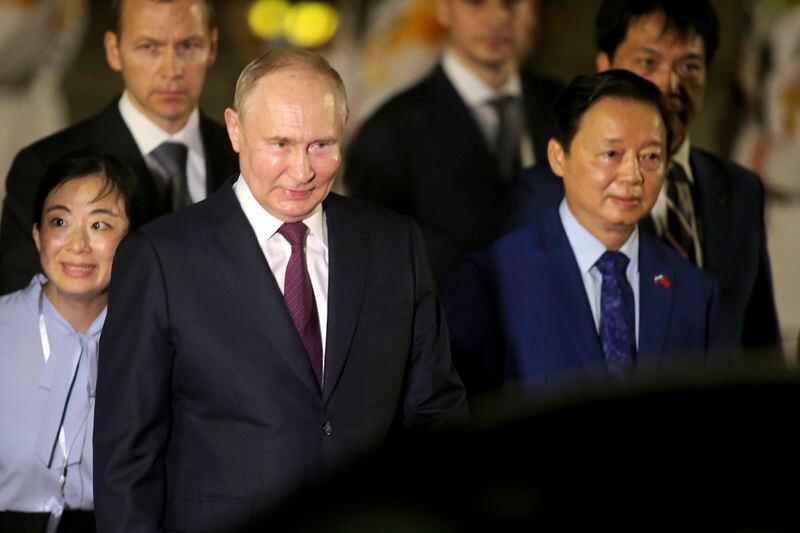 Russian President Vladimir Putin, left, and Vietnamese Deputy Prime Minister Tran Hong Ha walk together after Putin's arrival at the Noi Bai International Airport in Hanoi, Vietnam, Thursday, June. 20, 2024. (AP Photo/Minh Hoang)