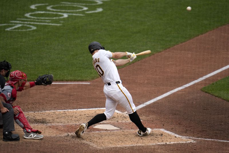 Pittsburgh Pirates' Bryan Reynolds hits a solo home run off Cincinnati Reds relief pitcher Nick Martinez during the eighth inning of a baseball game in Pittsburgh, Wednesday, June 19, 2024. (AP Photo/Gene J. Puskar)