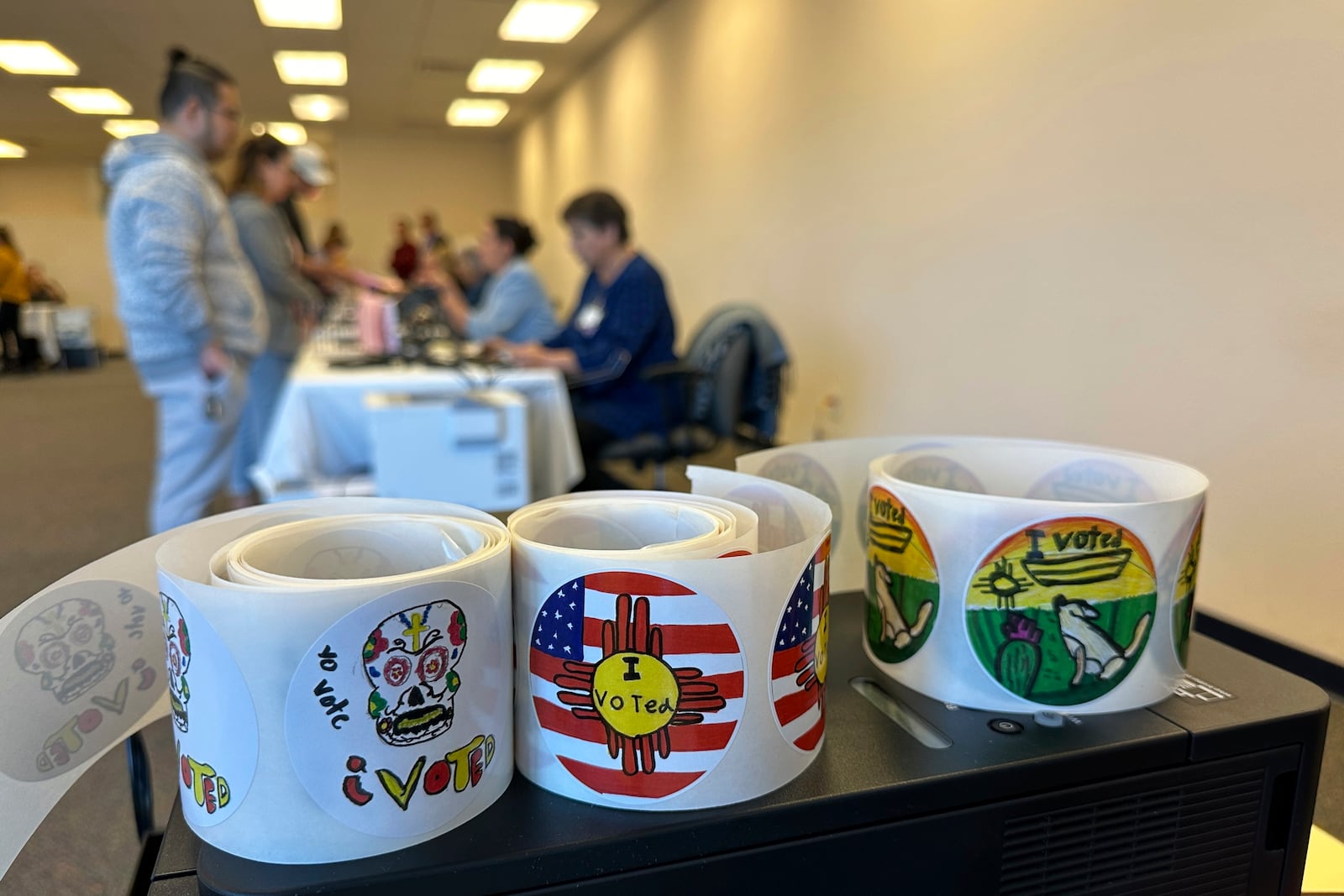 Rolls of I Voted stickers that were designed by students as part of a contest sit on a desk at an early voting center in Albuquerque, N.M., on Wednesday, Oct. 30, 2024. (AP Photo/Susan Montoya Bryan)