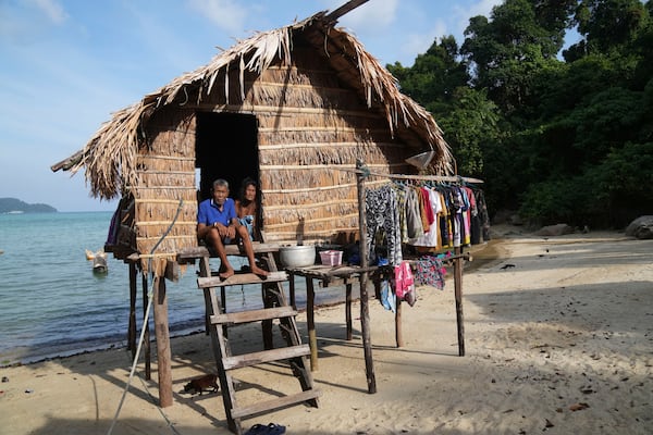 Jepen Klathale and his wife Boomkoyoung Klathale sit on their house in Moken village at Surin Islands in Phang Nga Province, Thailand, Wednesday, Dec. 11, 2024. (AP Photo/Sakchai Lalit)