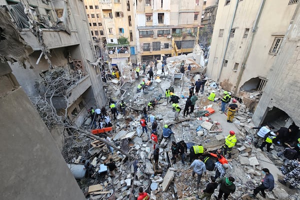 Rescuers search for victims at the site of an Israeli airstrike that targeted a building in Beirut, Lebanon, Tuesday, Nov. 26, 2024. (AP Photo/Hassan Ammar)