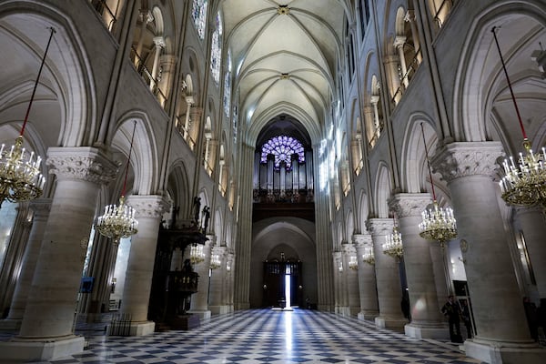 The nave, the western Rose stainless window and the organ of Notre-Dame de Paris cathedral are seen while French President Emmanuel Macron visits the restored interiors of the monument, Friday Nov. 29, 2024, in Paris. (Stephane de Sakutin, Pool via AP)