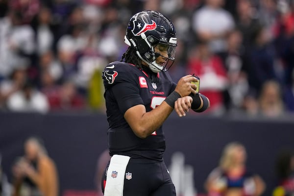 Houston Texans quarterback C.J. Stroud checks his play chart during the first half of an NFL wild-card playoff football game against the Los Angeles Chargers Saturday, Jan. 11, 2025, in Houston. (AP Photo/Eric Christian Smith)