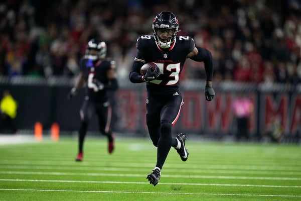 Houston Texans safety Eric Murray (23) returns an interception for a touchdown against the Los Angeles Chargers during the second half of an NFL wild-card playoff football game Saturday, Jan. 11, 2025, in Houston. (AP Photo/Eric Christian Smith)