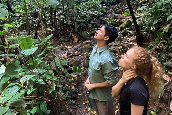 FILE - Biologists Jim Córdoba-Alfaro, left, and Jenna Lawson listen for the sounds of endangered Geoffrey's spider monkeys at the private Rio Nuevo Nature Reserve on the Osa Peninsula in Costa Rica, on March 20, 2023. (AP Photo/Matt O'Brien, File)