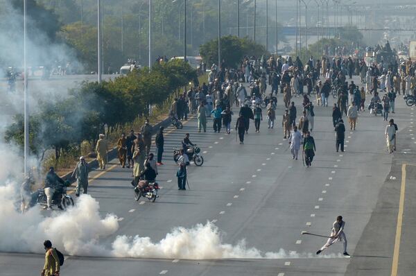 Police fire tear gas shell to disperse supporters of imprisoned former premier Imran Khan's Pakistan Tehreek-e-Insaf party, during clashes, in Islamabad, Pakistan, Tuesday, Nov. 26, 2024. (AP Photo/Irtisham Ahmed)