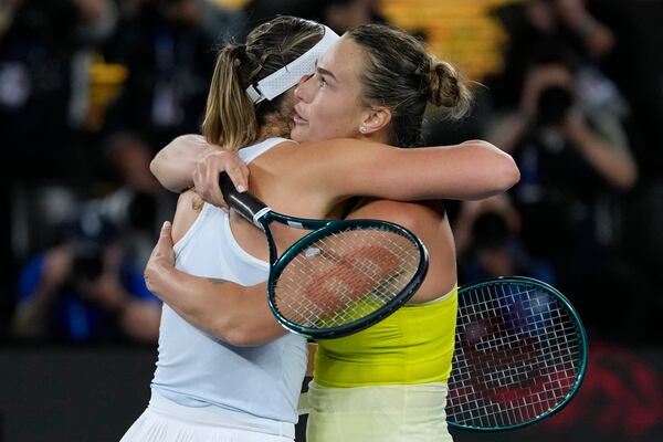 Aryna Sabalenka, right, of Belarus is congratulated by Paula Badosa of Spain following during their semifinal match at the Australian Open tennis championship in Melbourne, Australia, Thursday, Jan. 23, 2025. (AP Photo/Ng Han Guan)