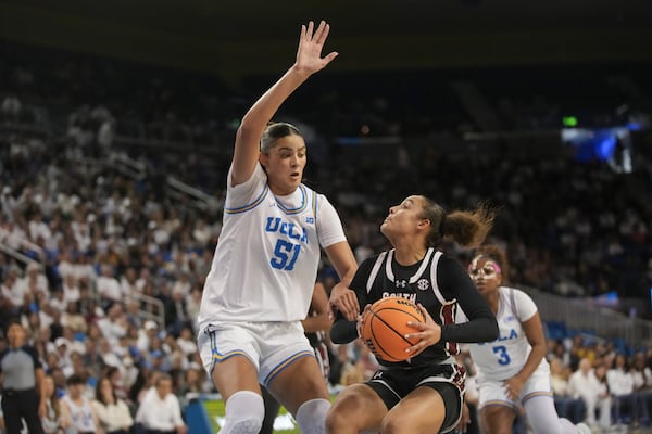 South Carolina guard Tessa Johnson drives against UCLA center Lauren Betts (51) during the first half of an NCAA college basketball game, Sunday, Nov. 24, 2024, in Los Angeles. (AP Photo/Eric Thayer)