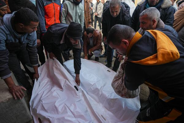 Mourners attend the funeral of three members of Imad Al-deen family who were killed in the Israeli bombardment in Bureij, central Gaza Strip, at Al-Aqsa Martyrs Hospital in Deir al-Balah, Monday, Jan. 6, 2025. (AP Photo/Abdel Kareem Hana)