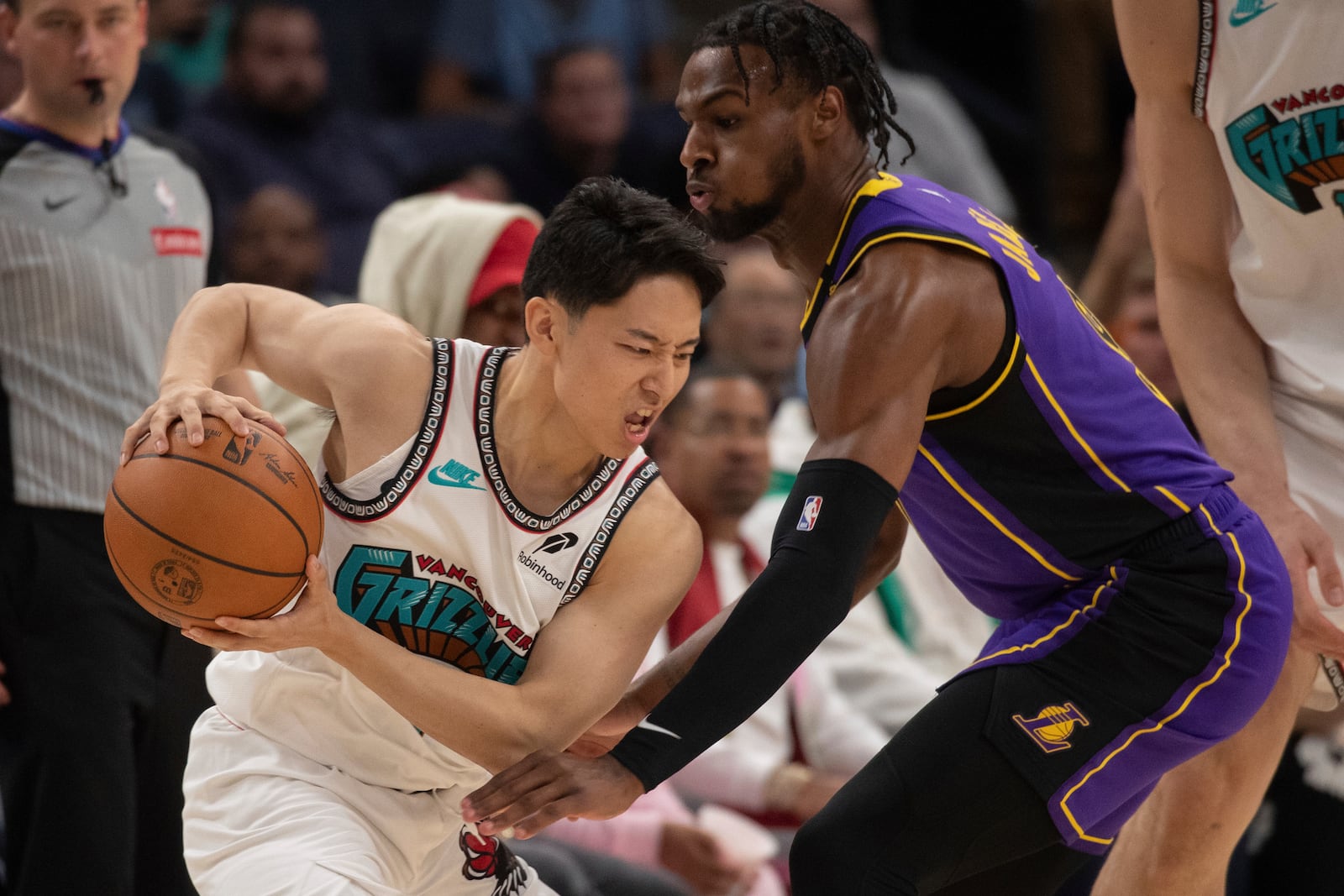 Los Angeles Lakers guard Bronny James (9) defends Memphis Grizzlies guard Yuki Kawamura (17), of Japan, in the second half of an NBA basketball game Wednesday, Nov. 6, 2024, in Memphis, Tenn. (AP Photo/Nikki Boertman)