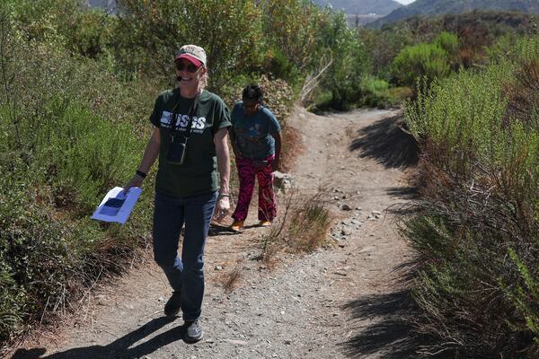 Kate Scharer, a research geologist with the Earthquake Science Center of the US Geological Survey, left, walks with Shirley Jackson, an adjunct professor of general geology at York College, during an accessible field trip to the San Andreas Fault organized by the International Association of Geoscience Diversity Thursday, Sept. 26, 2024, in San Bernadino, Calif. (AP Photo/Ryan Sun)