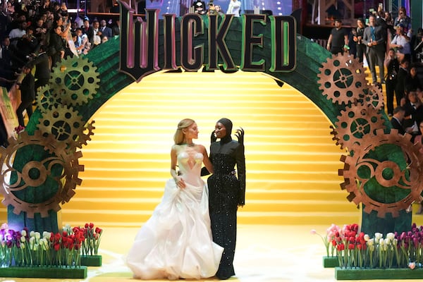 FILE - Cynthia Erivo, right, and Ariana Grande pose for the photographers prior to the the premiere of "Wicked" at Auditorio Nacional in Mexico City, Monday, Nov. 11, 2024. In “Wicked,” Elphaba and Glinda travel from Shiz University to the Emerald City on a glistening green train to meet the wizard. In real life, Cynthia Erivo and Ariana Grande have traveled much farther and wider and longer and on airplanes to promote their hotly anticipated film. (AP Photo/Fernando Llano, File)