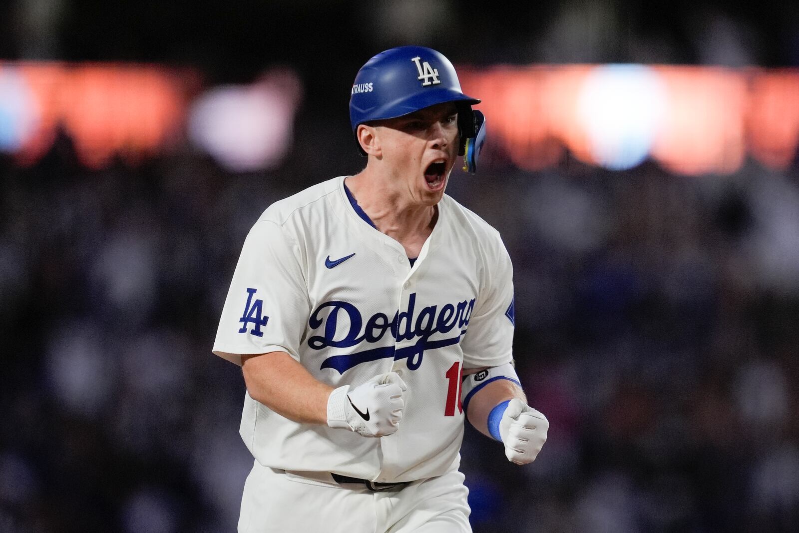 Los Angeles Dodgers' Will Smith celebrates a two-run home run against the New York Mets during the third inning in Game 6 of a baseball NL Championship Series, Sunday, Oct. 20, 2024, in Los Angeles.(AP Photo/Ashley Landis)