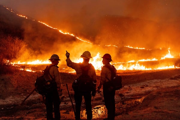 Fire crews battle the Kenneth Fire in the West Hills section of Los Angeles, Thursday, Jan. 9, 2025. (AP Photo/Ethan Swope)