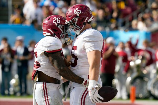 Alabama tight end Robbie Ouzts (45) celebrates his touchdown against Michigan with running back Jam Miller (26) during the first half of the ReliaQuest Bowl NCAA college football game Tuesday, Dec. 31, 2024, in Tampa, Fla. (AP Photo/Chris O'Meara)