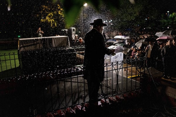 A rabbi delivers an eulogy next to the coffin containing the remains of Israeli-Moldovan rabbi Zvi Kogan in Kfar Chabad, Israel, Monday Nov. 25, 2024. Kogan, 28, an ultra-Orthodox rabbi, was killed last week in Dubai where he ran a kosher grocery store. Israelis have flocked for commerce and tourism since the two countries forged diplomatic ties in the 2020 Abraham Accords.(AP Photo/Ohad Zwigenberg)