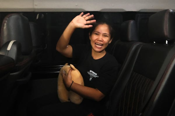 Filipino death row inmate Mary Jane Veloso waves to the media as she leaves Yogyakarta Women's Prison for her transfer to the capital city of Jakarta in preparation for her repatriation to the Philippines, in Gunung Kidul, Indonesia, Sunday, Dec. 15, 2024. (AP Photo/Slamet Riyadi)