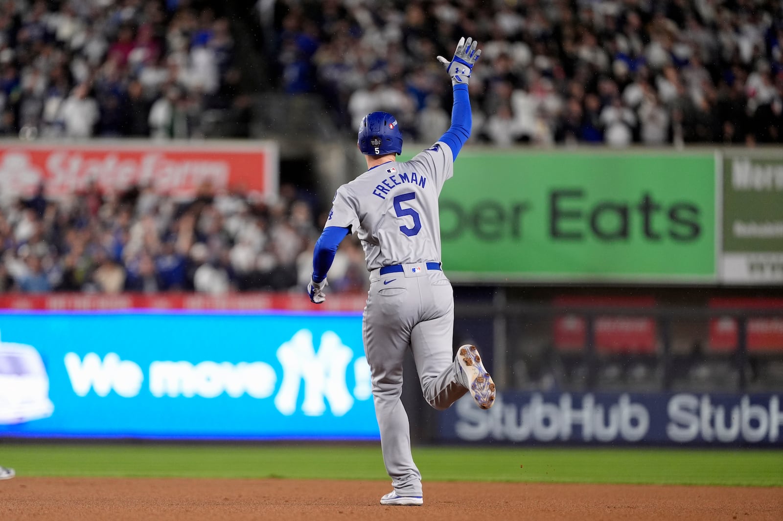 Los Angeles Dodgers' Freddie Freeman celebrates after hitting a two-run home run against the New York Yankees during the first inning in Game 4 of the baseball World Series, Tuesday, Oct. 29, 2024, in New York. (AP Photo/Godofredo A. Vásquez)