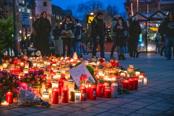 Numerous candles are placed in Aschaffenburg, Germany, Thursday, Jan. 23, 2025 following the fatal attack in a park. (Daniel Vogl/dpa via AP)