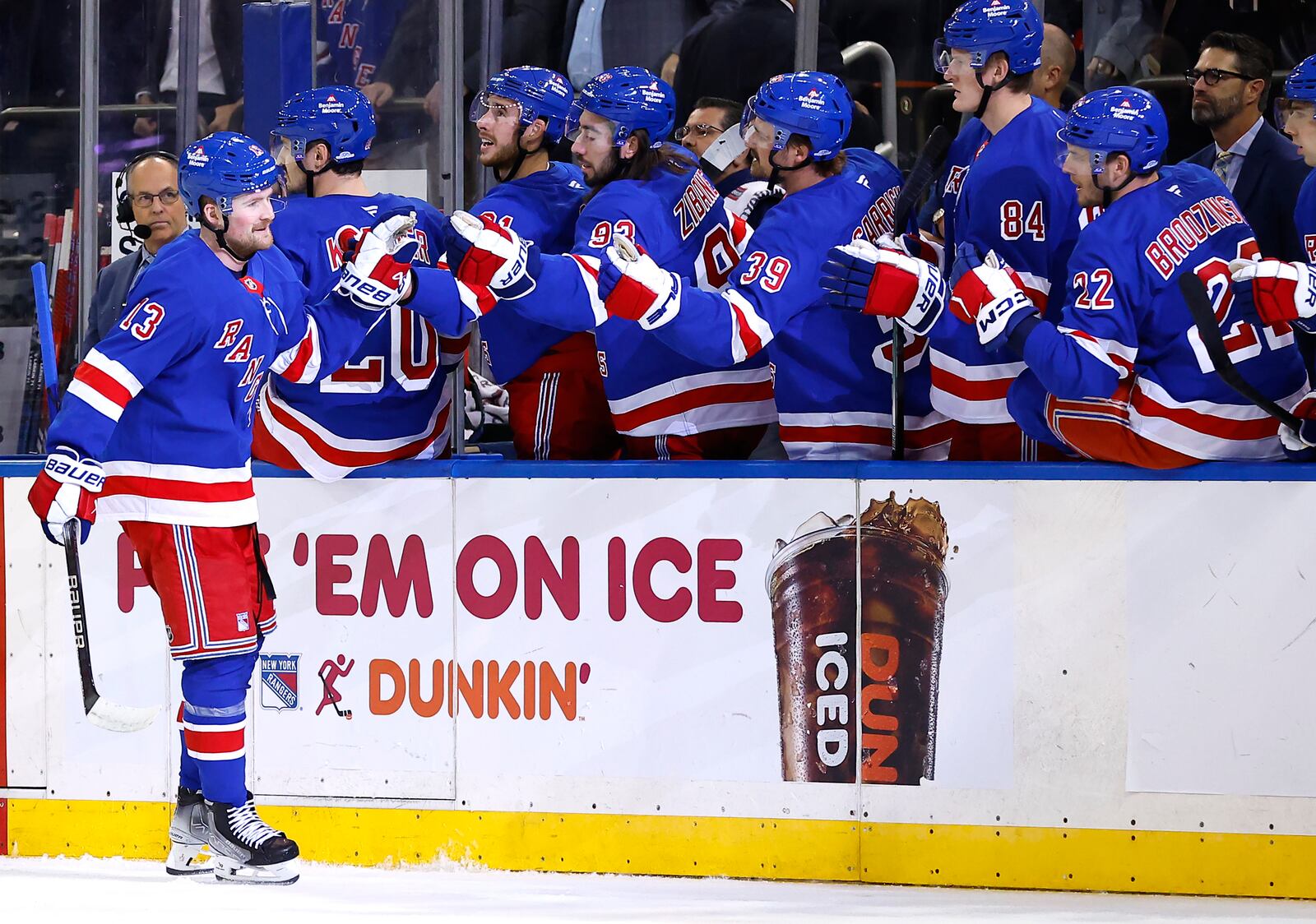 New York Rangers left wing Alexis Lafrenière (13) celebrates with teammates after scoring a goal against the Detroit Red Wings during the first period of a hockey game, Monday, Oct. 14, 2024, in New York. (AP Photo/Noah K. Murray)