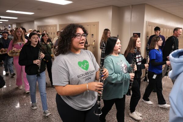 Leslie Hernandez, center, practices with the Middletown High School band in the hallways of the school, Tuesday, Jan. 14, 2025, in Middletown, Ohio. The band is set to participate in the inauguration of President-elect Donald Trump on Jan. 20. Middletown is the hometown of Vice President-elect JD Vance.(AP Photo/Kareem Elgazzar)