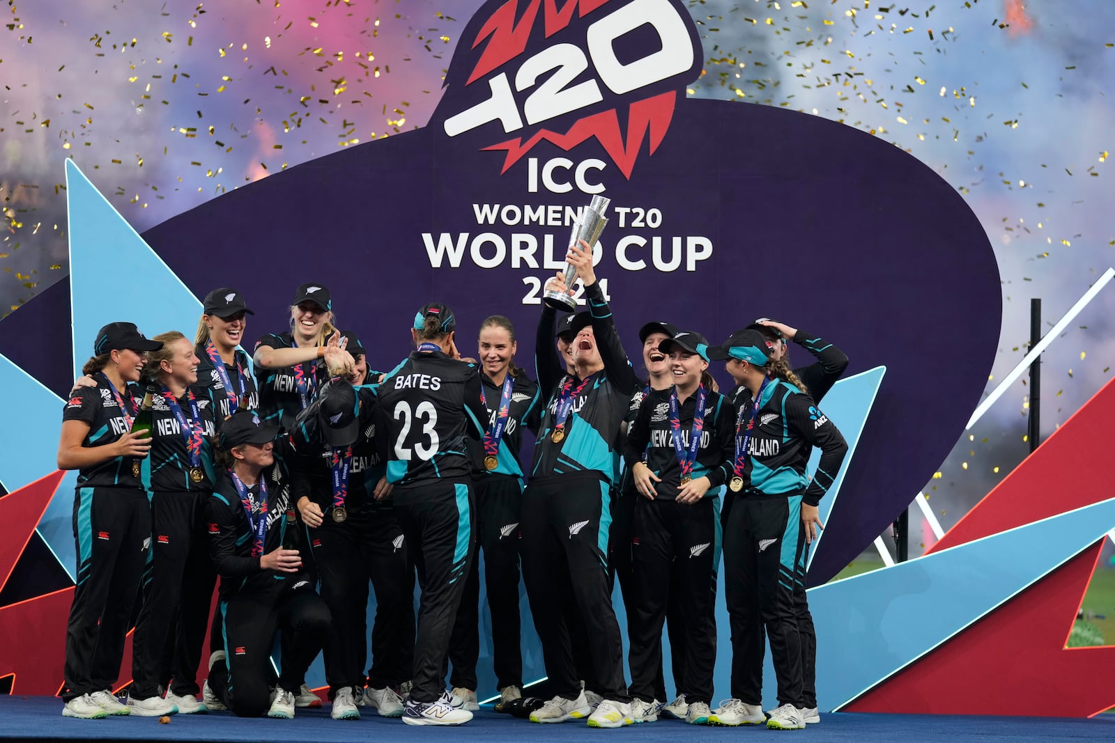 New Zealand's players celebrate with the trophy after winning the ICC Women's T20 World Cup 2024 final match against South Africa at Dubai International Cricket Stadium, United Arab Emirates, Sunday, Oct. 20, 2024. (AP Photo/Altaf Qadri)