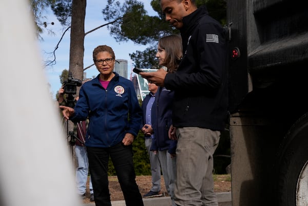 Los Angeles Mayor Karen Bass tours a staging area Wednesday, Jan. 22, 2025 in Los Angeles, where city workers prepare to reinforce burned land ahead of rains expected this weekend. (AP Photo/Brittany Peterson)