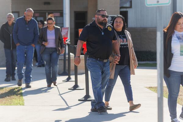 Javier and Gloria Cazares, center, the parents of Jacklyn Cazares who was killed in the May 2022 Robb Elementary mass shooting along with 18 other children and two teachers, walk out of the Uvalde County Justice Center after attending a pretrial hearing for two officers, Thursday morning, Dec. 19, 2024, in Uvalde, Texas. (Sam Owens/The San Antonio Express-News via AP)