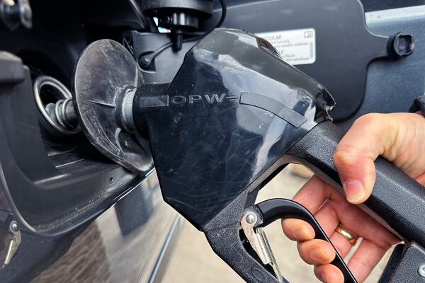 FILE - A customer pumps gas at a gas station in Mundelein, Ill., Feb. 8, 2024. (AP Photo/Nam Y. Huh, file)