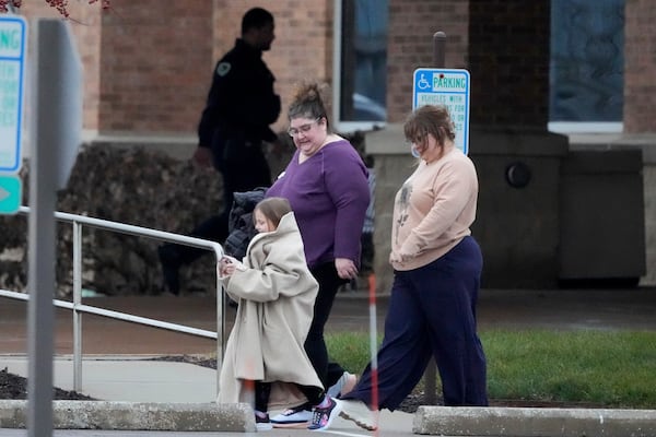 Family leaves from a shelter at the Abundant Life Christian School in Madison, Wis., following a shooting, Monday, Dec. 16, 2024. (AP Photo/Morry Gash)