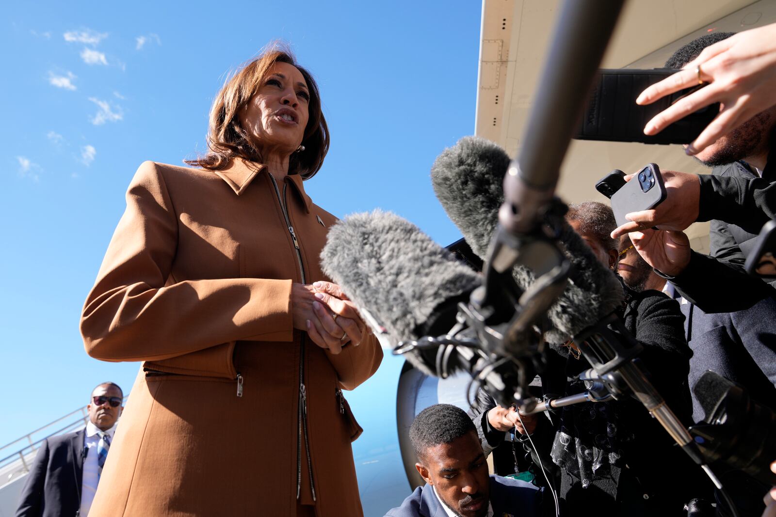 Democratic presidential nominee Vice President Kamala Harris speaks with reporters upon arriving at Kellogg Regional Airport in Battle Creek, Mich., Saturday, Oct. 26, 2024. (AP Photo/Jacquelyn Martin)