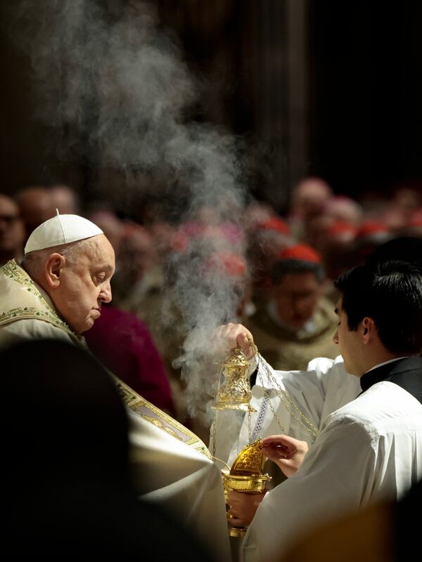 Pope Francis, left, celebrates a Christmas Eve Mass on the day the Pope opens the Holy Door to mark the opening of the 2025 Catholic Holy Year, or Jubilee, in St. Peter's Basilica, at the Vatican, Dec. 24, 2024. (Remo Casilli/Pool Photo via AP)