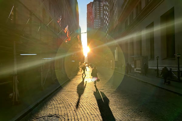 People walk on Wall Street in New York's Financial District on Wednesday, Dec. 18, 2024. (AP Photo/Peter Morgan, File)