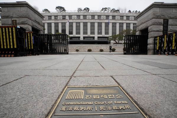 A sign of the Constitutional Court is seen on the ground in front of the court's building in Seoul, South Korea, Monday, Dec. 16, 2024. (AP Photo/Ahn Young-joon)