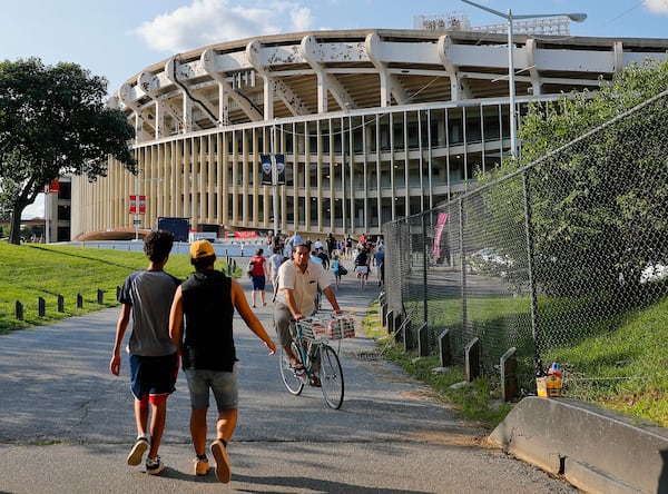 FILE - In this Aug. 5, 2017, file photo people make their way to RFK Stadium in Washington before an MLS soccer match between D.C. United and Toronto FC. (AP Photo/Pablo Martinez Monsivais, File)