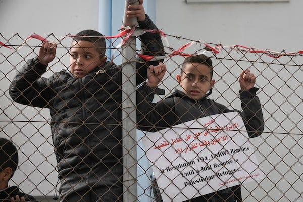 Palestinian youth demonstrate in front a UNRWA (UN agency for Palestinian refugees) clinic at the Qalandia refugee camp, to protest the Israel parliament decision preventing the agency to continue its work, in Qalandia Monday Nov. 2024. The laws ban the agency, UNRWA, from operating and cut all ties between the agency and the Israeli government.(AP Photo/Mahmoud Illean)