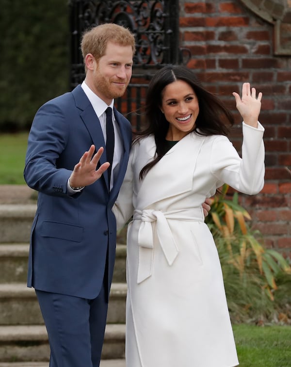 FILE -Britain's Prince Harry and his fiancee Meghan Markle pose for photographers during a photocall in the grounds of Kensington Palace in London, Nov. 27, 2017. (AP Photo/Matt Dunham, File)