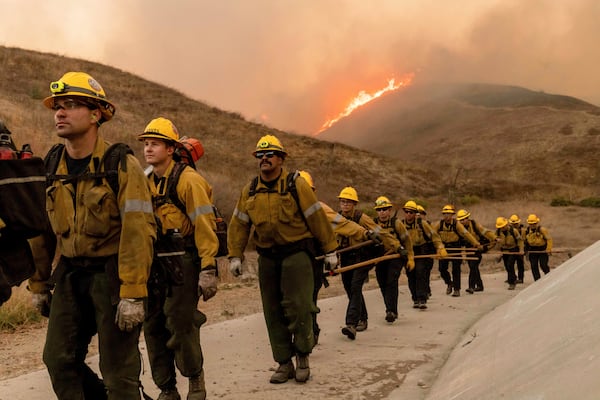 Fire crews battle the Kenneth Fire in the West Hills section of Los Angeles, Thursday, Jan. 9, 2025. (AP Photo/Ethan Swope)