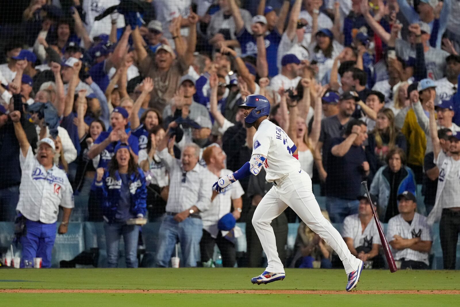 Los Angeles Dodgers' Teoscar Hernández watches his two-run home run during the third inning in Game 2 of the baseball World Series against the New York Yankees, Saturday, Oct. 26, 2024, in Los Angeles. (AP Photo/Mark J. Terrill)