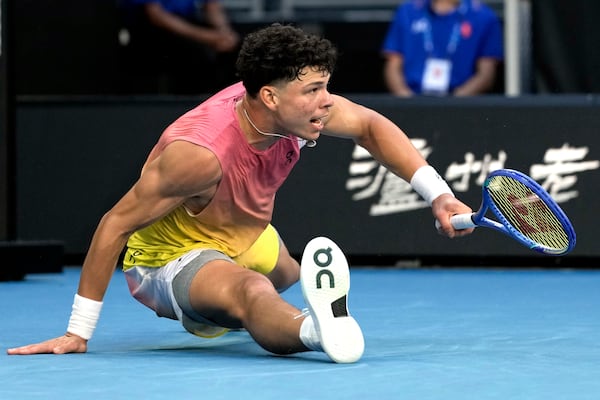 Ben Shelton of the U.S. falls during his third round match against Lorenzo Musetti of Italy at the Australian Open tennis championship in Melbourne, Australia, Saturday, Jan. 18, 2025. (AP Photo/Ng Han Guan)