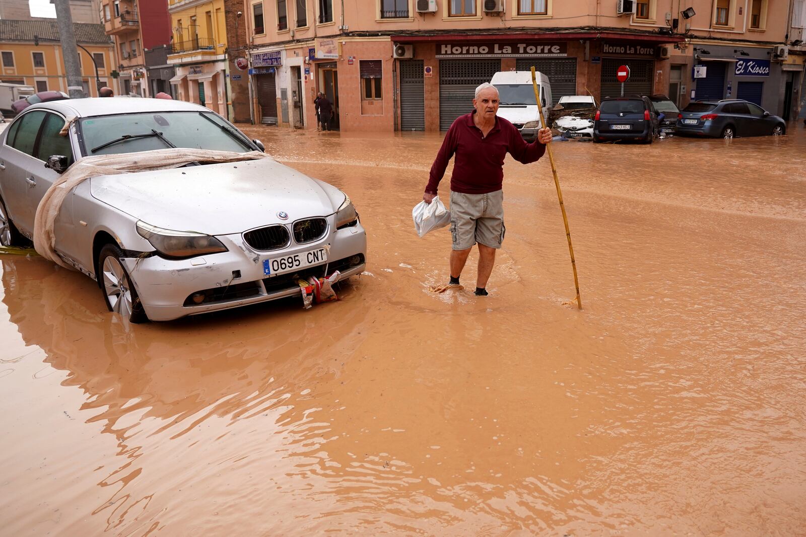 A man walks through flooded streets in Valencia, Spain, Wednesday, Oct. 30, 2024. (AP Photo/Alberto Saiz)