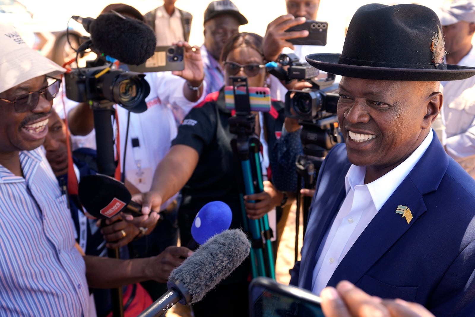 Botswana Democratic Party President Mokgweetsi Masisi speaks to journalist after casting his vote during during an election to decide if it keeps faith with one of the Africa's longest-ruling parties, at a Mosielele primary school in Moshupa village, southern District of Botswana, Wednesday, Oct. 30, 2024. (AP Photo/Themba Hadebe)