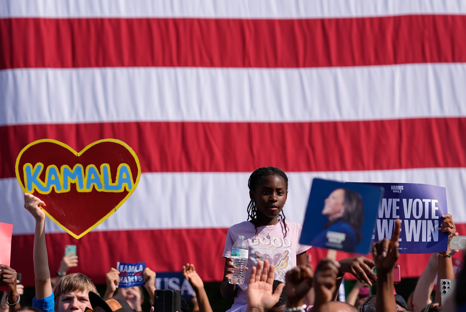 Supporters watch as Democratic presidential nominee Vice President Kamala Harris speaks during a campaign rally outside the Atlanta Civic Center, Saturday, Nov. 2, 2024. (AP Photo/Brynn Anderson)