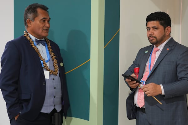 Toeolesulusulu Cedric Schuster, Samoa environment minister, waits outside a room at the COP29 U.N. Climate Summit, Friday, Nov. 22, 2024, in Baku, Azerbaijan. (AP Photo/Peter Dejong)