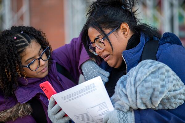 Venezuelan migrants Ruthmervis Tiamo, right, and her daughter Sofia Ferrer become emotional while having a video chat with relatives in their home country after entering the United States from Ciudad Juarez, Mexico through the Paso del Norte bridge, Monday, Jan. 20, 2025 in El Paso, Texas. (AP Photo/Andres Leighton)