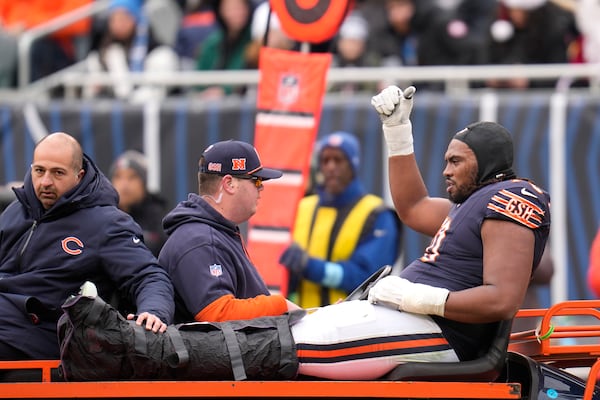 Chicago Bears offensive tackle Braxton Jones gives the thumbs up sign as he is carted off the field during the first half of an NFL football game against the Detroit Lions on Sunday, Dec. 22, 2024, in Chicago. (AP Photo/Erin Hooley)