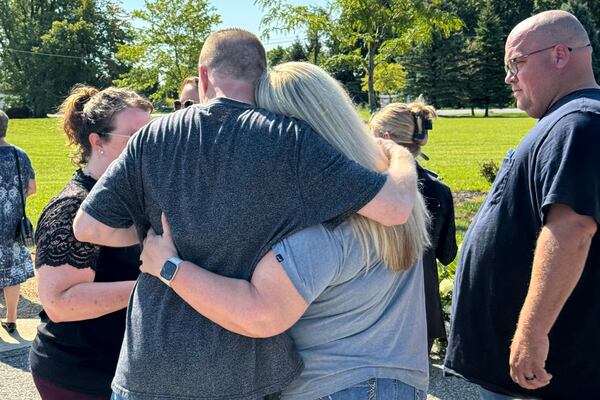 Shannon Doughty and her cousin, Eric Pranger, embrace on Aug. 29, 2024, in Westfield, Indiana, during the dedication of a memorial to the known victims of suspected serial killer Herbert Baumeister, including Doughty's brother, Allen Livingston. (AP Photo/Rick Callahan)